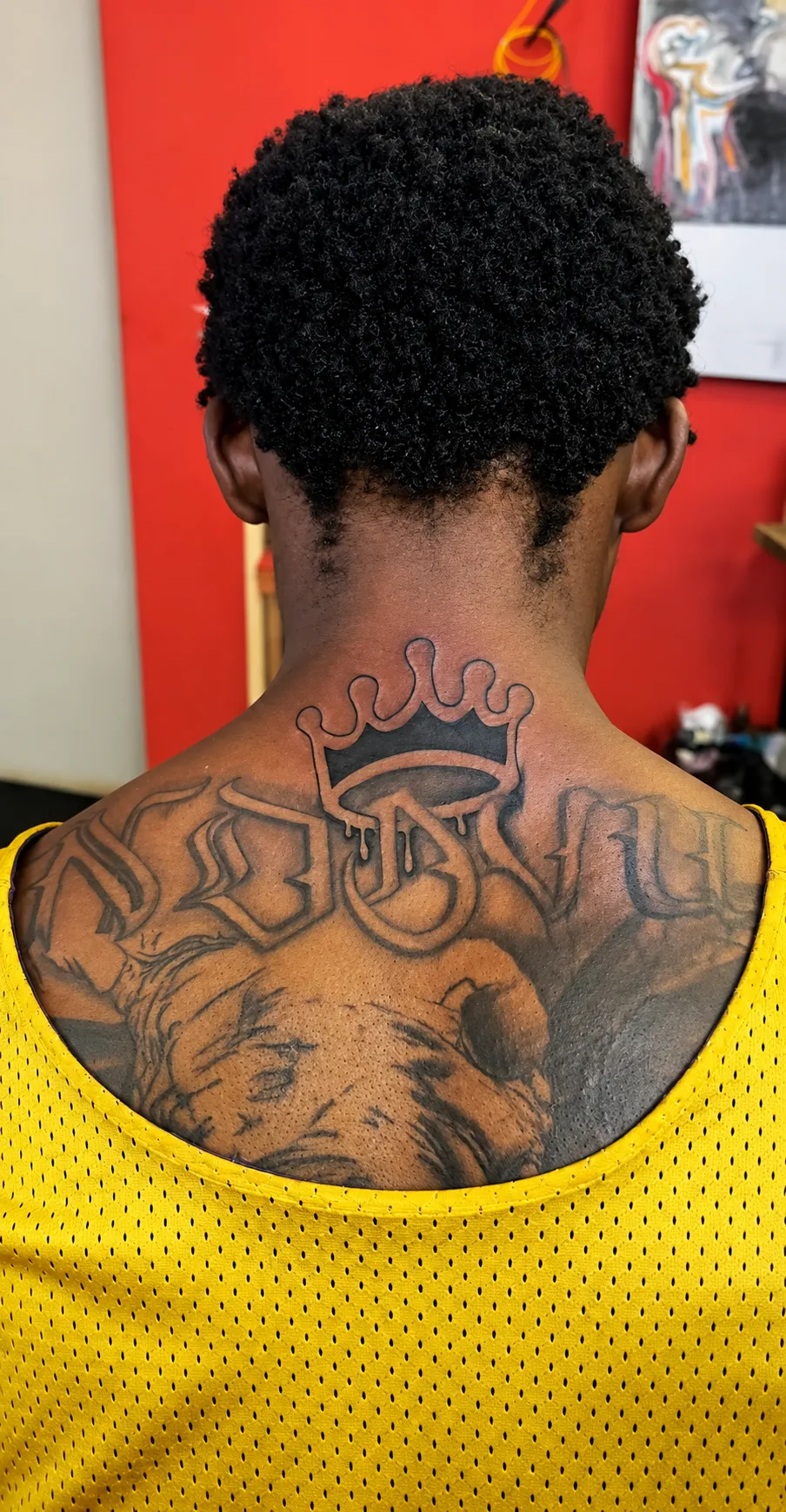 Jay of Inking Tattoos photographed from behind, showing his upper-back tattoo artwork